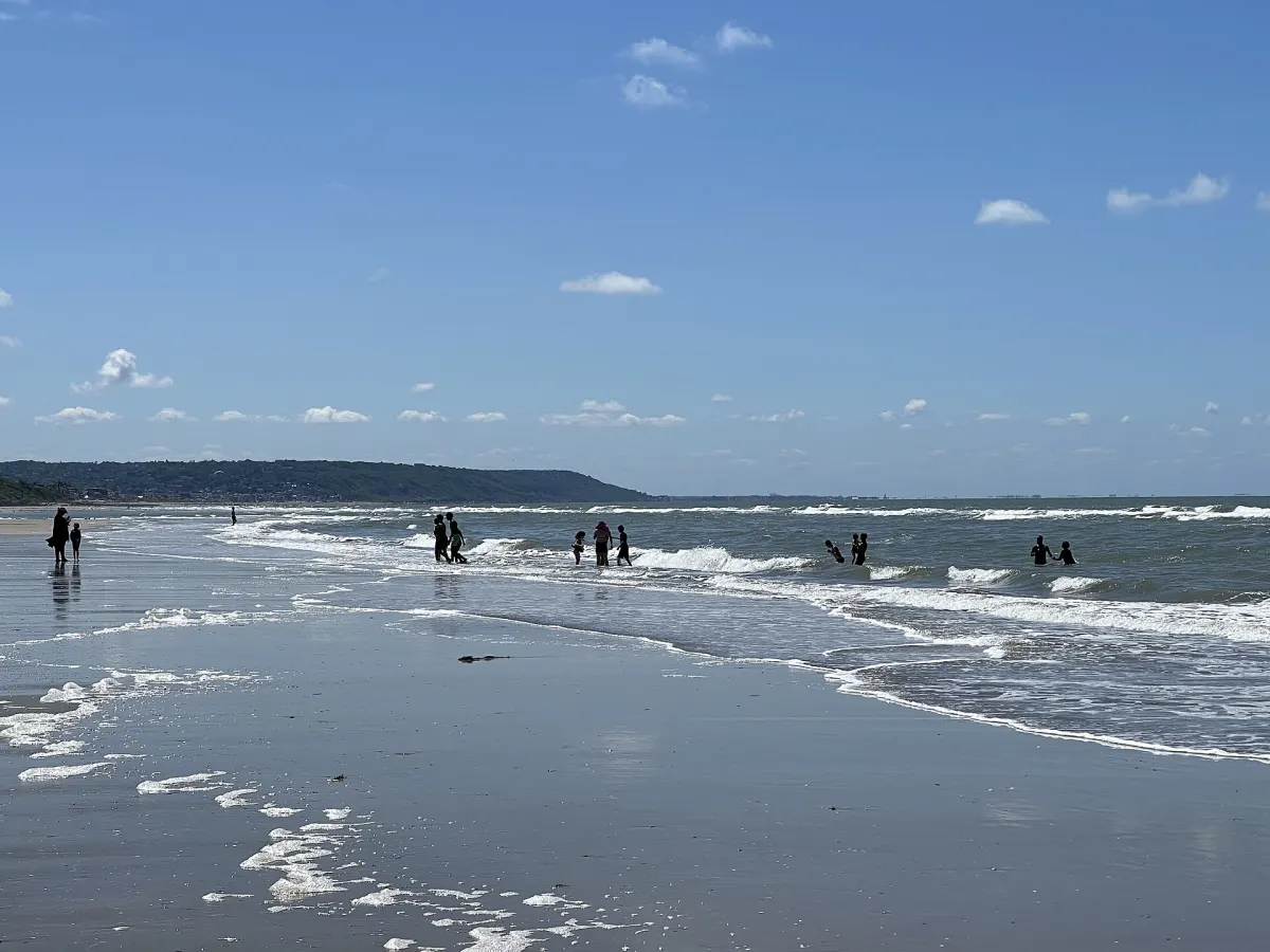 Beach at Deauville with parasols and the sea on a summer day